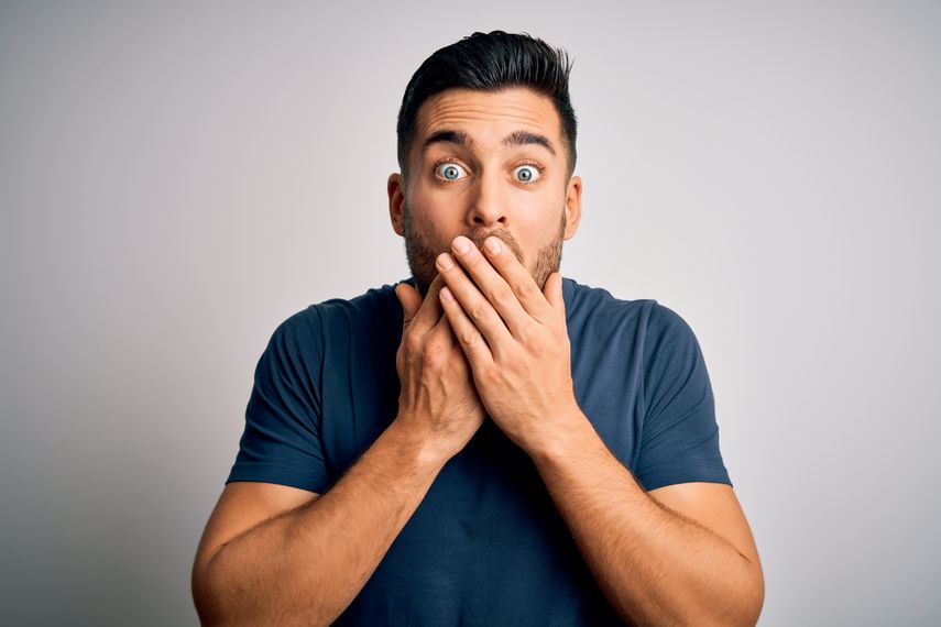surprised man with hands over mouth