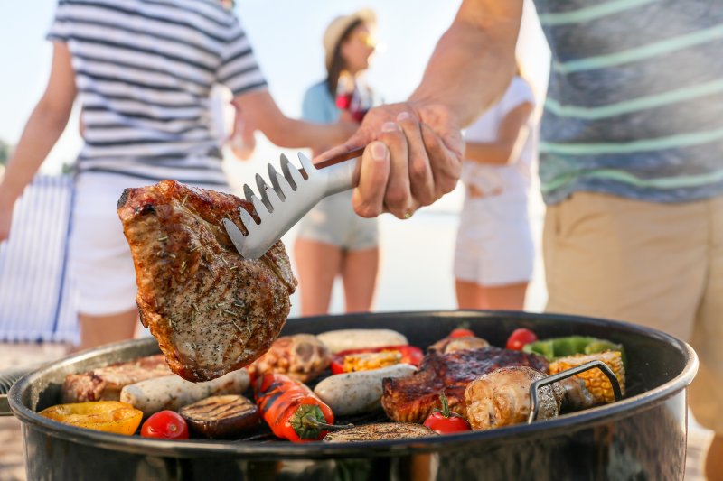 person grilling summer foods